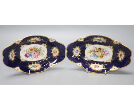 A pair of Royal Worcester blue ground floral painted dishes by E Phillips, signed date code for 1894, length 21cm