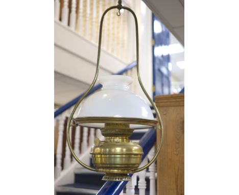 A Victorian brass hanging oil lamp, with a white opaque glass shade, drop 90cm