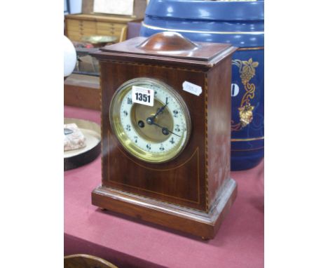 An Edwardian Mahogany Inlaid Mantel Clock, with circular dial, Arabic numerals, on plinth base and gilded brass bun feet, wit