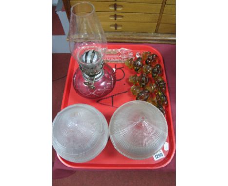 Oil Lamp with Cranberry Glass Well, eight amber glass drawer knobs, two glass shades, lustre drops:- One Tray