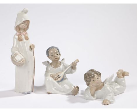 Three Lladro figures, depicting two angels, one playing the lute and one lying down, and a girl holding a basket and cane, th