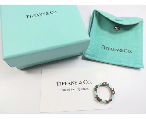 A Tiffany silver and turquoise enamel ring with pouch and box. 