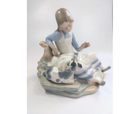 Nao seated girl with goat, 28cm wide by 24cm high. 