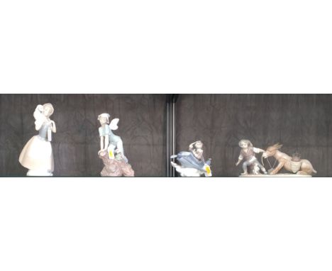 Three Lladro figures including Boy with Donkey 27cm wide and a Nao figure of Girl with Lamb 26cm (4) 