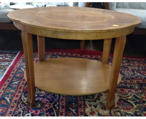 An Art Deco low coffee table with shaped top, fluted legs and inlaid top and under tier 50cm x 72cm x 50cm. 