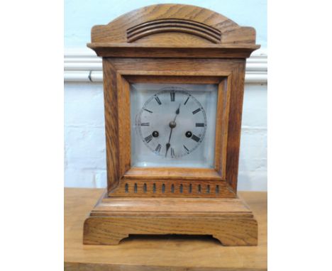 A Carved Oak mantel clock (number 5867). Together with keys and a pendulum. Circa 1910 