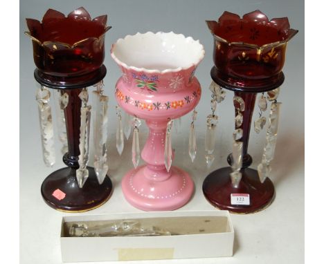 A pair of late Victorian ruby glass pedestal lustres, with faceted glass drops, all heightened in gilt (worn); and one other 