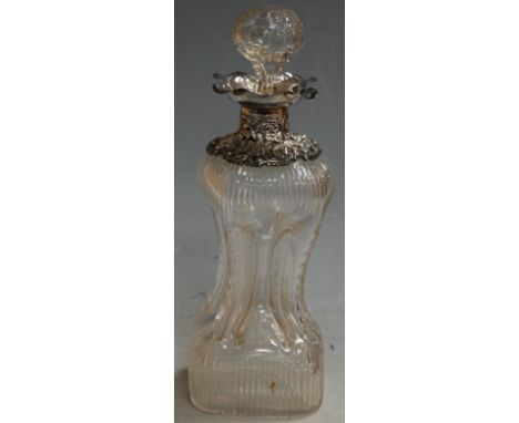 A late Victorian glass decanter and stopper of hour glass form with silver collar