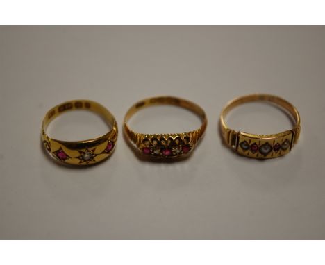 A ladies 18ct gold ruby and diamond set dress ring; one other similar example; and a yellow metal ruby and seed pearl set rin