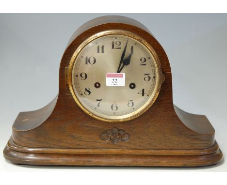 An oak  cased striking mantel clock