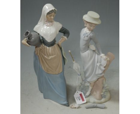 A Lladro figure modelled as a  girl beside a treestump holding an umbrella (a/f), together with a Nao figure of a water carri