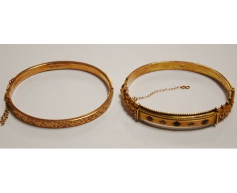 A 9ct gold ruby and diamond point set hinged bangle; and one other engraved example, gross weight 10.3g (2) Condition Report 