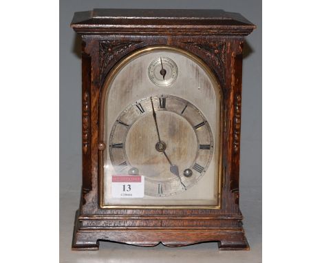 An early 20th century oak cased mantel clock with striking movement