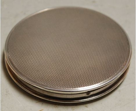 A mid-20th century ladies silver compact with all-over engine turned decoration 