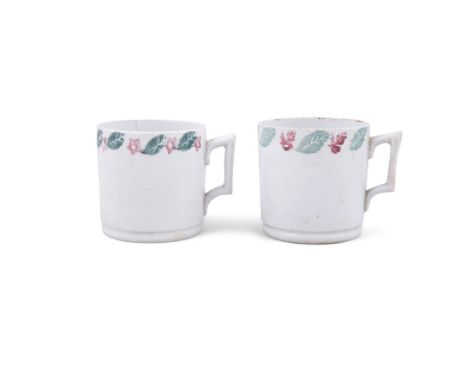 A PAIR OF SECOND PERIOD BELLEEK SPONGEWARE MUGS, in light green glaze decorated with leaves and flowers in red and green (2)