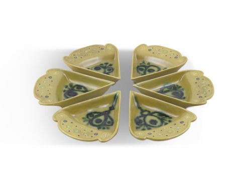 JOHN FFRENCH ARKLOW POTTERY PLATESmoulded as cake slices, covered in light green glaze decorated with flowers, with shaped ri