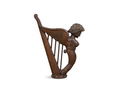 A 19TH CENTURY STAINED CARVED WOODEN MODEL OF HIBERNIA HARP, and raised on a circular base. 81cm high
