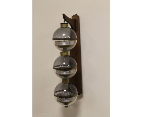 A MID 20TH CENTURY GERMAN MADE WALL HANGING WEATHER STATION, comprising three globes, containing a barometer, thermometer and