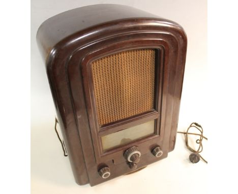 A 'FERRANTI' BROWN BAKELITE RADIO, with arched top and fabric speaker grills, marked 'All Wave Straight 8' H 45 cmBuyers - fo