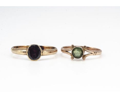 A peridot gold dress ring, marked 9ct, ring size K, and an early 19th Century garnet posey ring, ring size P, 2.9g 