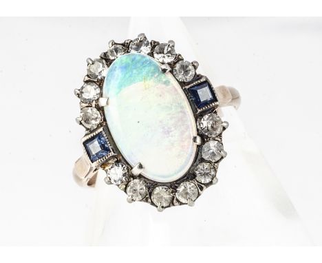 An opal and paste set dress ring, in white and gilt metal, the cluster mount with central oval claw set opal, ring size R 