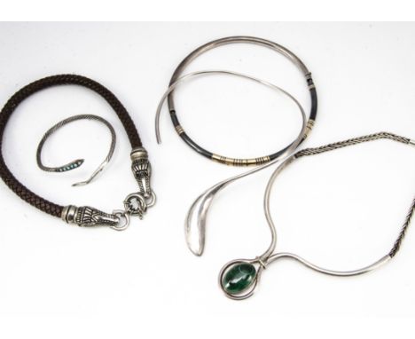 A collection of silver and white metal torques and necklaces, including a plaited leather and crocodile head necklace, anothe