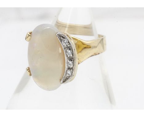 A contemporary white opal and paste stone dress ring, in a crossover style setting with a crescent of paste set stones to one