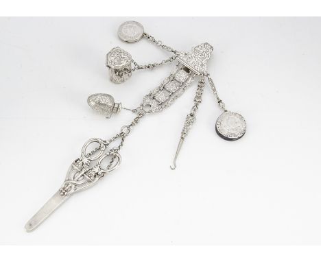 A fine 19th Century chatelaine, the belt hook with raised floral design, supporting seven fancy link chains with an interesti