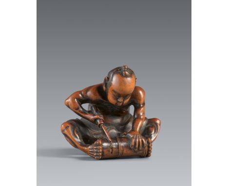 Netsuke eines Handwerkers. Buchsbaum. Edo. 3. Viertel 19. Jh.Sign.: Hoshunsai Masayuki und kaoSitzend, ein Bambusrohr, das er