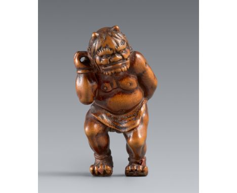 Netsuke eines wild dreinschauenden onis. Buchsbaum. 19. Jh.Stehend, der muskulöse Körper nur in ein Lendentuch und einen Fell