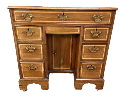 A fine George II style mahogany kneehole desk, mid 19th century, by S & H Jewell, Holborn, London,  with an satinwood and ebo