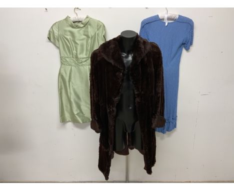 A 1940s fur coat together with a 1930s crepe swing dress with bow detailing and a 1960s silk cocktail dress. 