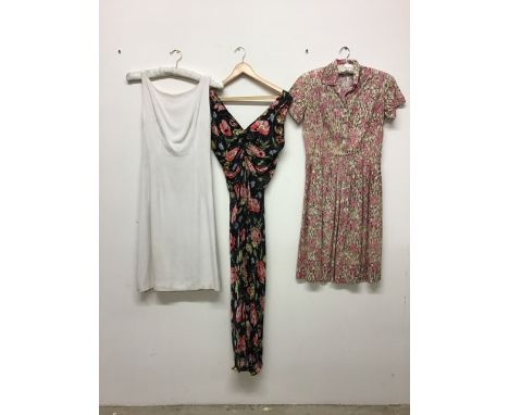 Three vintage fashion items to include a floral cotton 1940s dress a silk slip and a floral print example. 