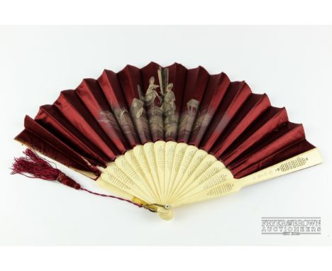 A late Victorian fan, the bone sticks and guards with pierced decoration, the burgundy satin leaves printed with a scene of a