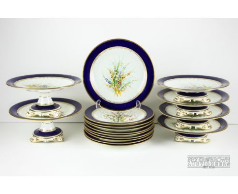 A Royal Worcester porcelain Scottish dessert service, painted with various heather sprays with a cobalt blue border gilded wi