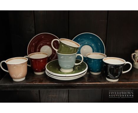 A Susie Cooper bone china set of six coffee cups &amp; saucers, each a different colour decorated with stylised white feather