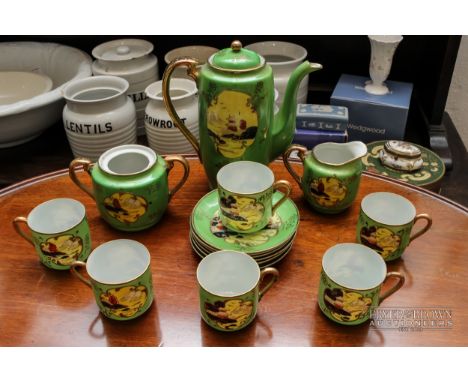 A 20th century Japanese part coffee service, the green ground decorated with reserves of landscape scenes in yellow, black an