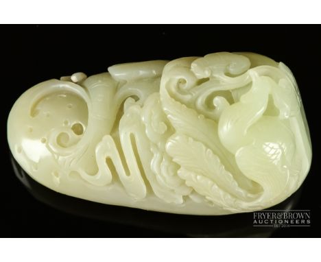 A Chinese mutton fat jade boulder carving, the small boulder carved with a ho ho bird amongst lingzhi and scrolls, 8cm