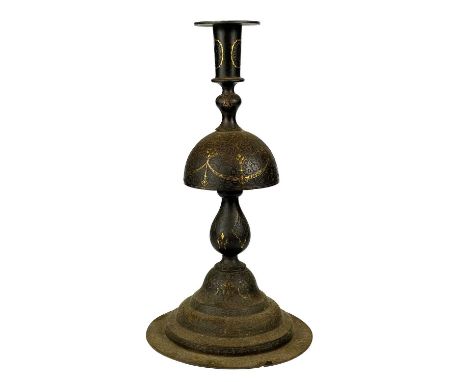 A Persia iron candlestick, 18th century. Gilt decorated throughout, height 29.5cm, diameter of base 15.5cm.From a Private Col