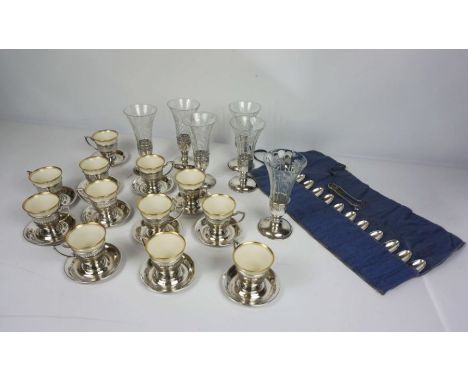 A set of six glass and silver mounted champagne flutes, together with a set of Lenox porcelain demitasse cups, each with a si