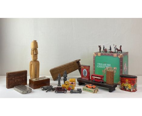 A mixed collection of toys to include three cribbage games, a carved wood Easter Island head, a vintage rattle, a collection 