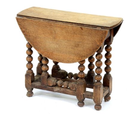 A miniature oak gateleg table, 19th / early 20th c, in Charles II style, the oval top on bobbin turned frame, 51cm h; 60 x 66