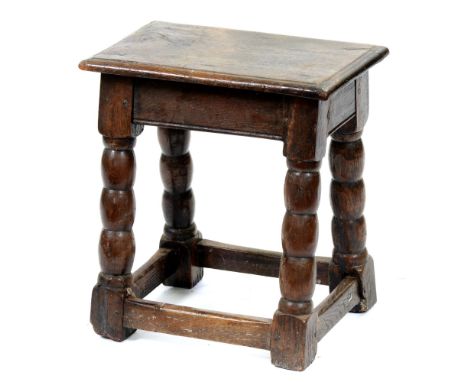 An oak joined stool, early 20th c, possibly incorporating earlier elements, in Charles II style, with bobbin turned legs, 47c
