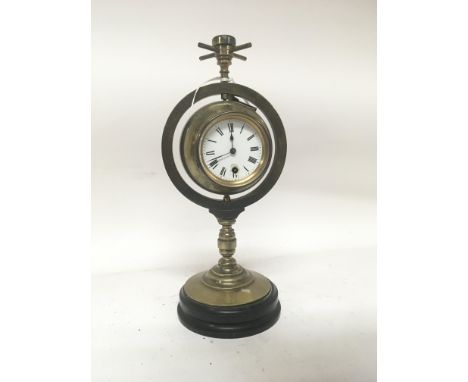 A Victorian brass clock barometer with a revolving Spherical ball. No Reserve. Height 33cm. With key