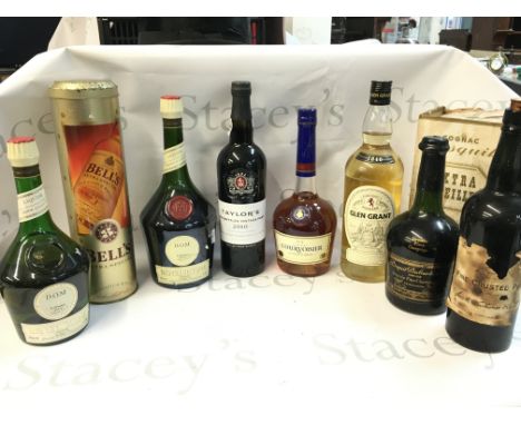 A collection of spirits including Dom Benedictine, Cognac Courvoisier, Glen Grant scotch whisky, Bisquit Dubouch & co cognac 