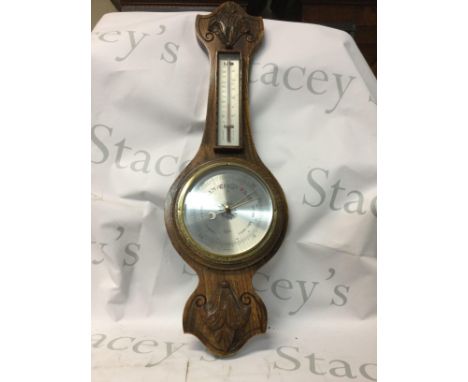 A collection of mixed items including an antique barometer, an antique clock, a wooden countryside African frame and an oil a