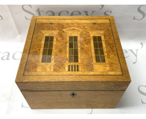 An inlaid wood humidor made by David Linley for Alfred Dunhill The top inlaid with a design inspired by Classical architectur