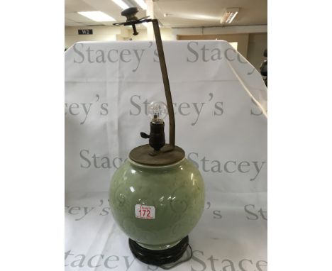 Chinese vase lamp on a pedestal.