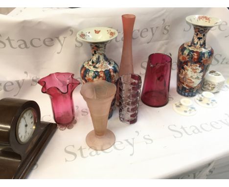 A collection of ceramics including Imari ware vases, pink glass vases, wooden mantle clock with inlaid design