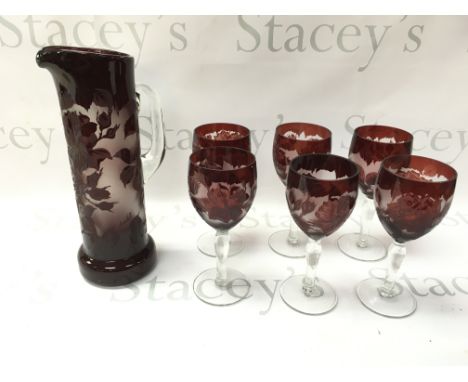 A set of cameo ruby flash wine glasses and a pitcher.